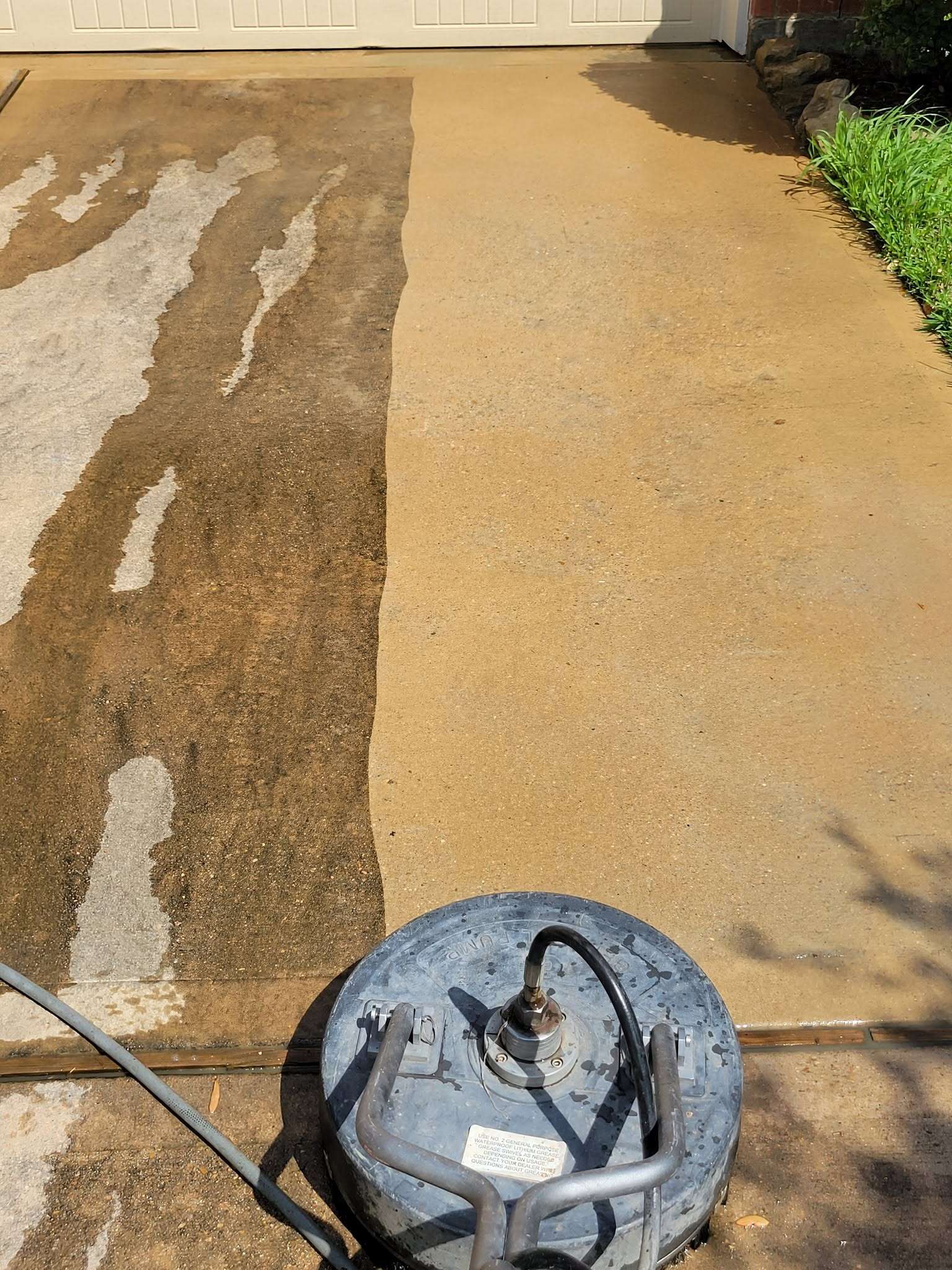 Surface cleaner removing dirt from a residential concrete driveway